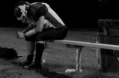 High school football player on bench